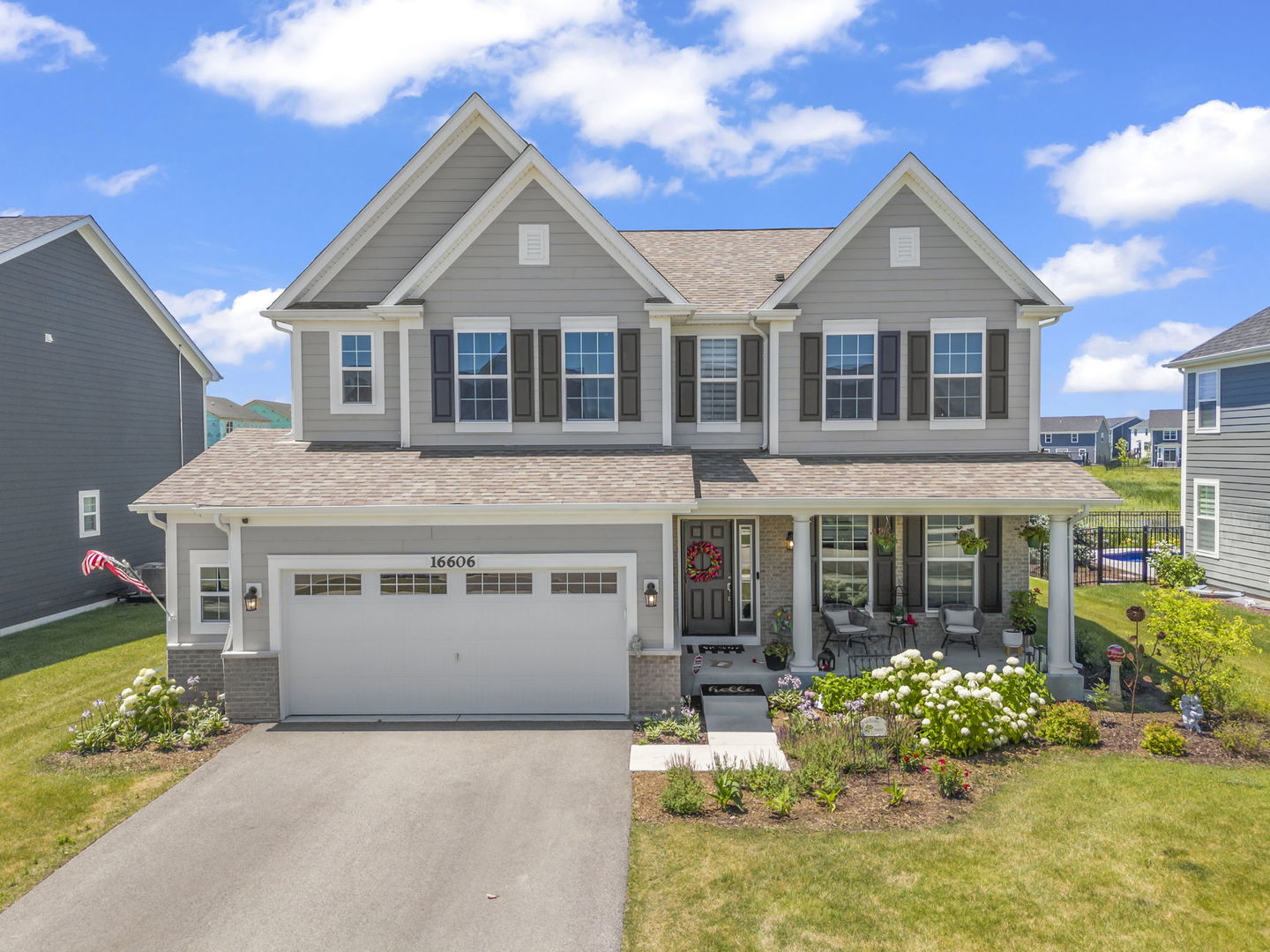 a front view of a house with a yard outdoor seating and garage