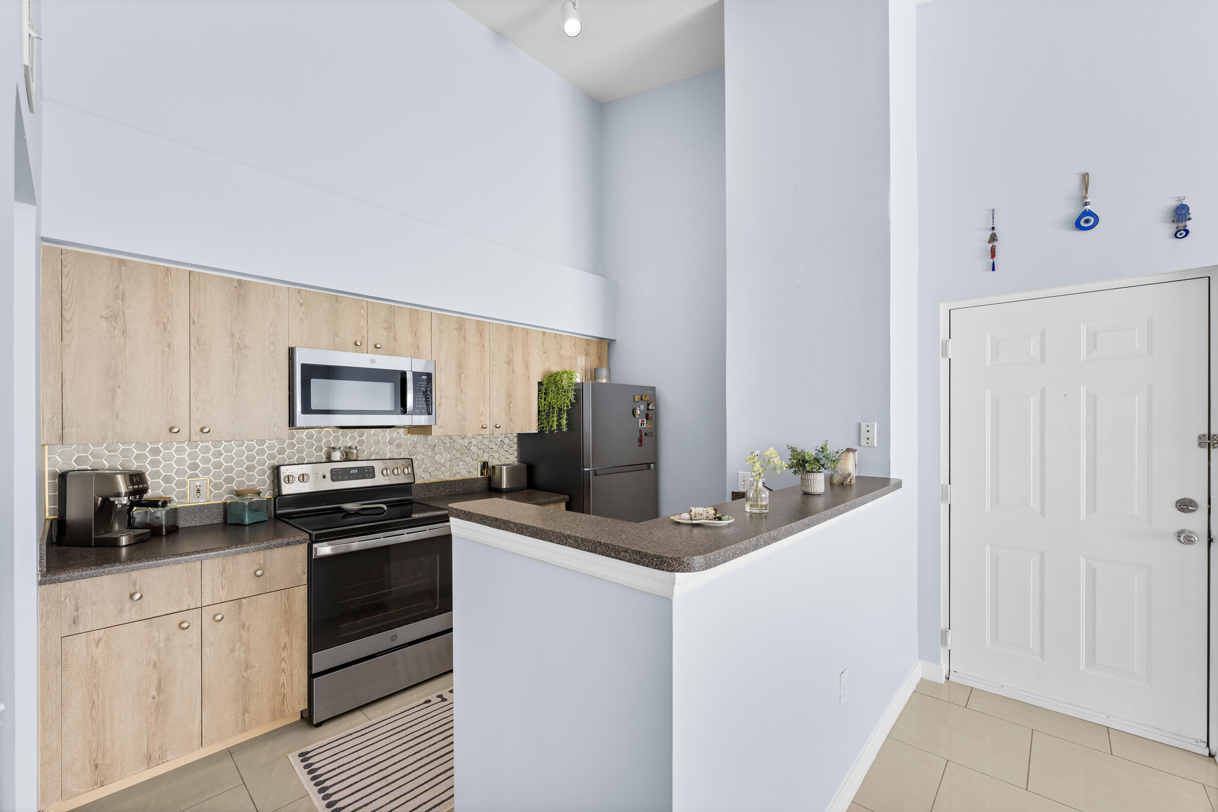 a kitchen with a sink stove and refrigerator