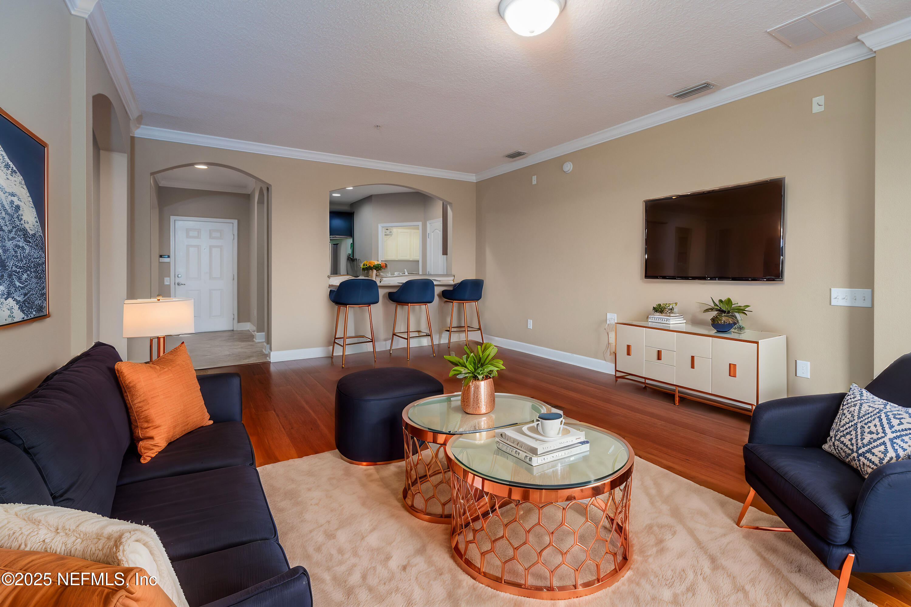 a living room with furniture and a flat screen tv