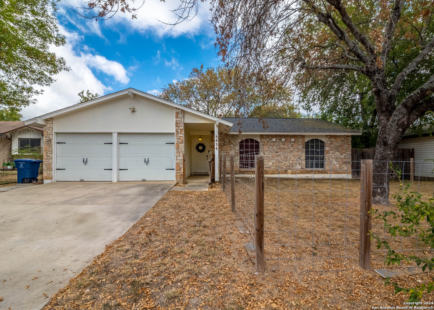 a front view of house with a yard and garage