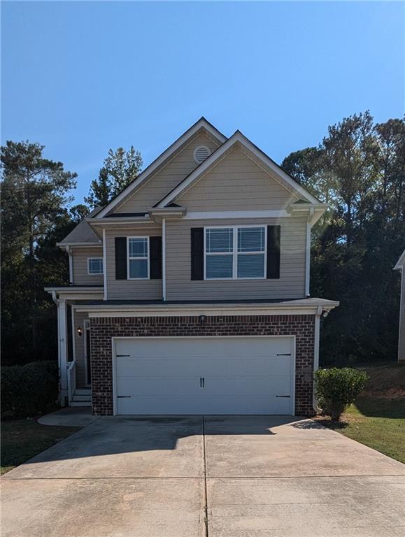 a front view of a house with garage