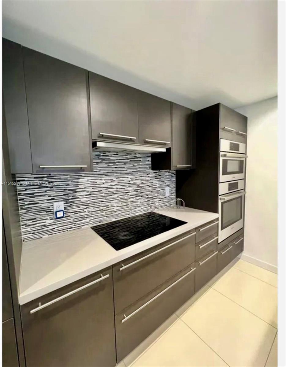 a kitchen with a sink and a refrigerator