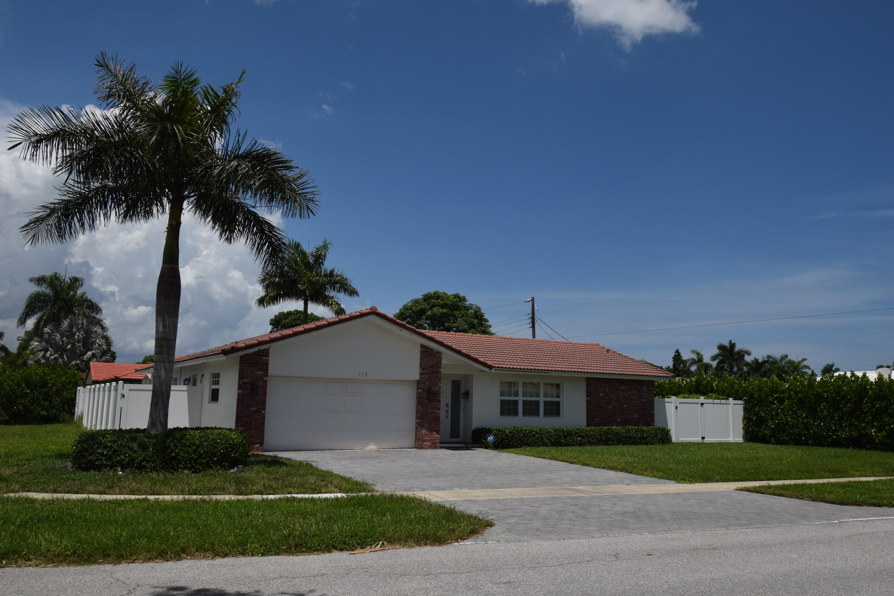 a front view of a house with a garden and a yard