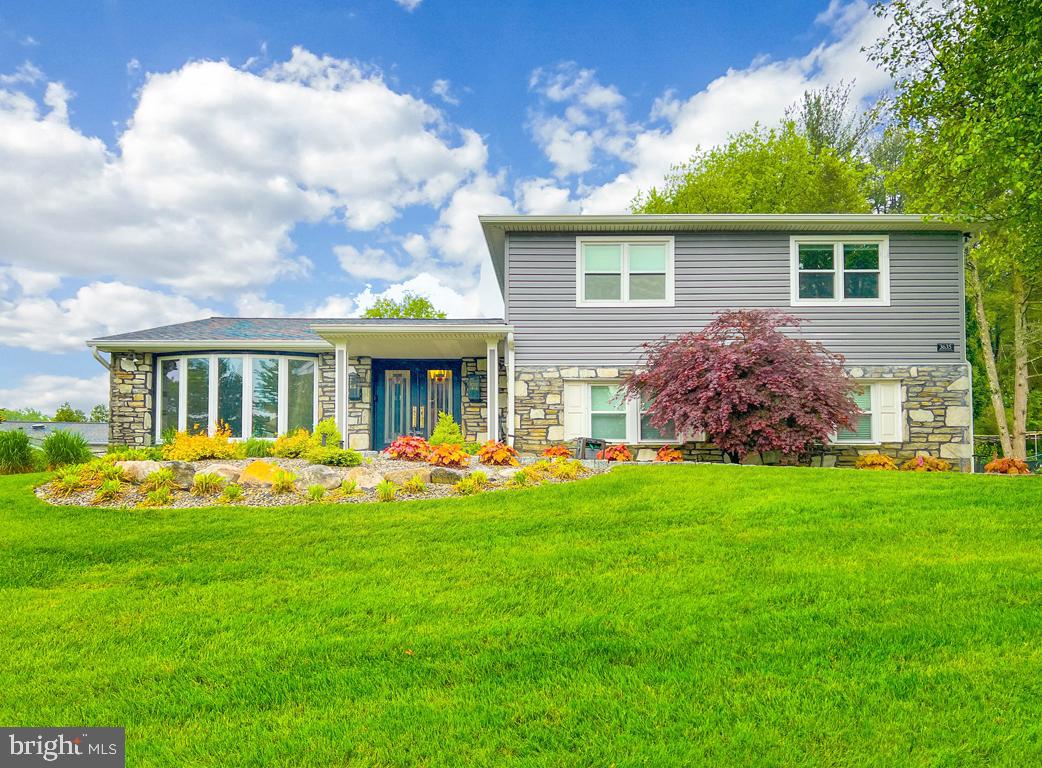 a front view of house with yard barbeque and outdoor seating