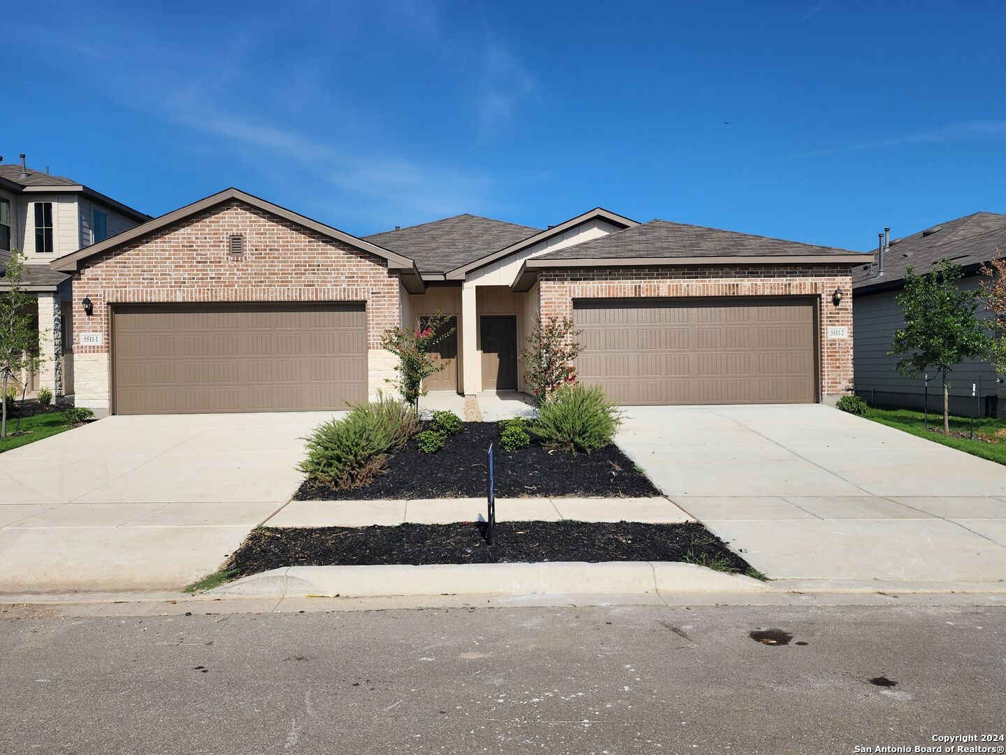 a view of a house with a yard and garage