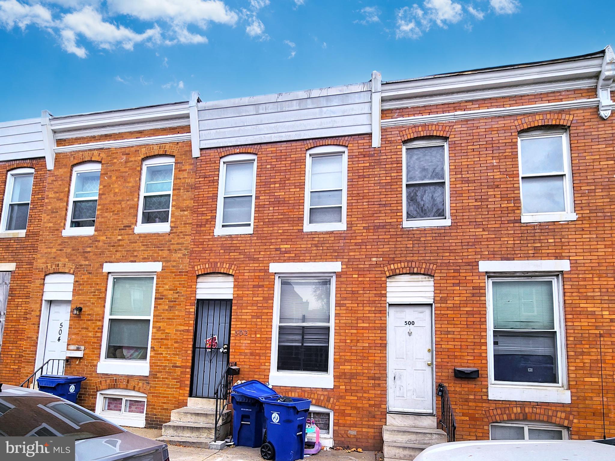 a front view of a brick building with many windows