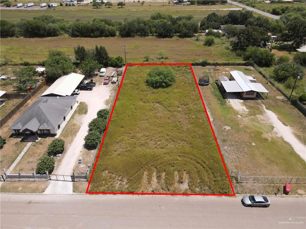 an aerial view of a house with a yard and lake view