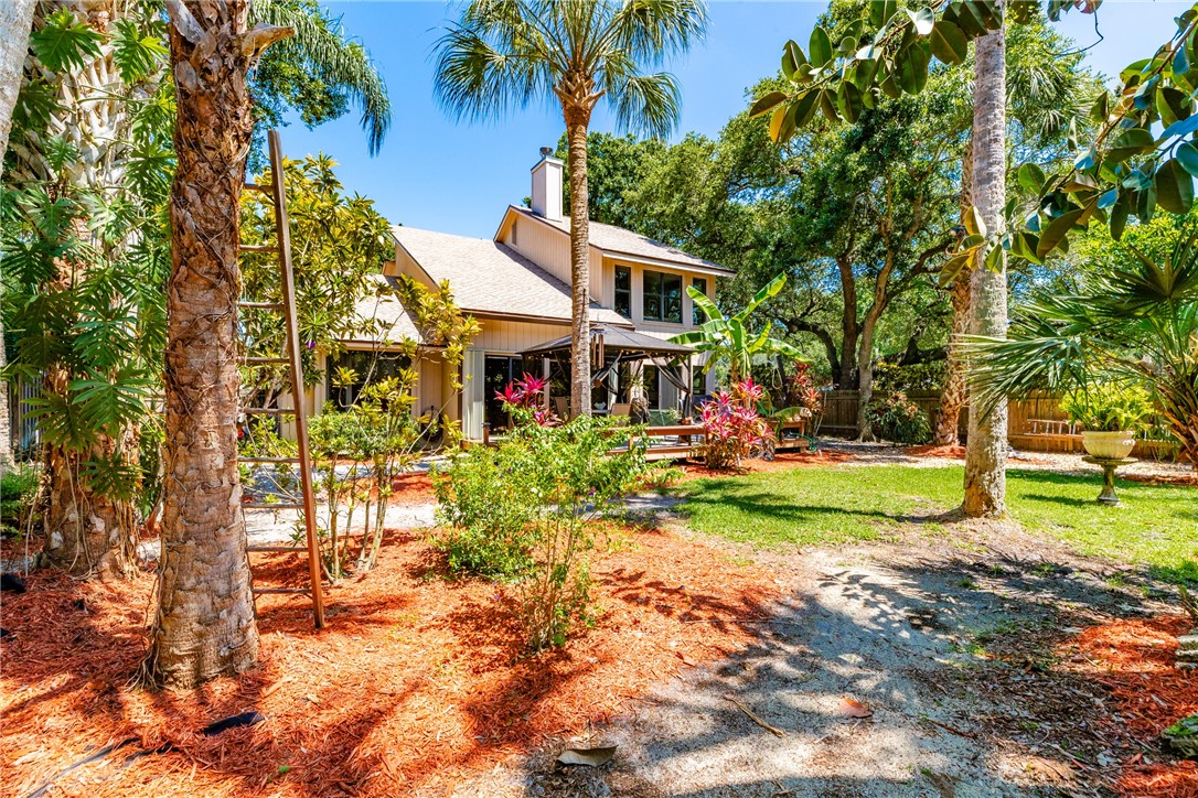 a view of a house with a yard and sitting area