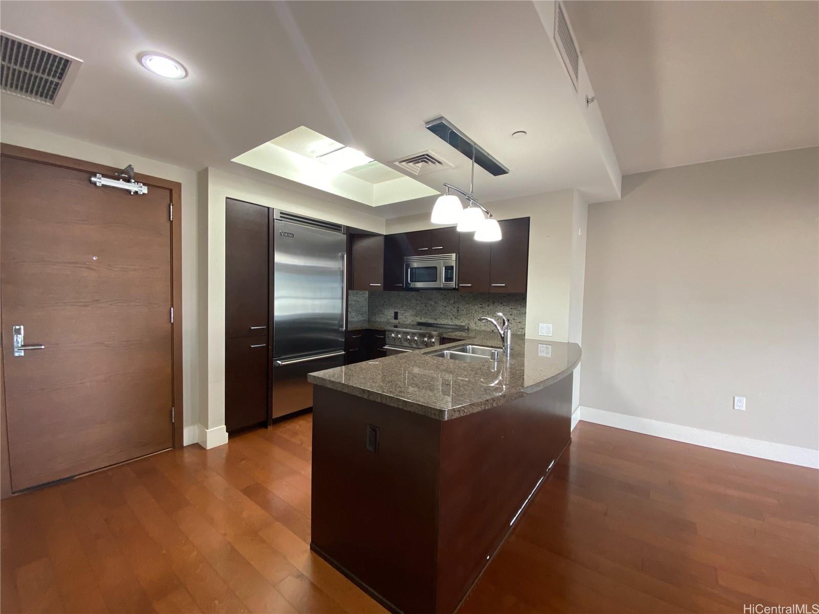 a kitchen with stainless steel appliances granite countertop a sink and a refrigerator