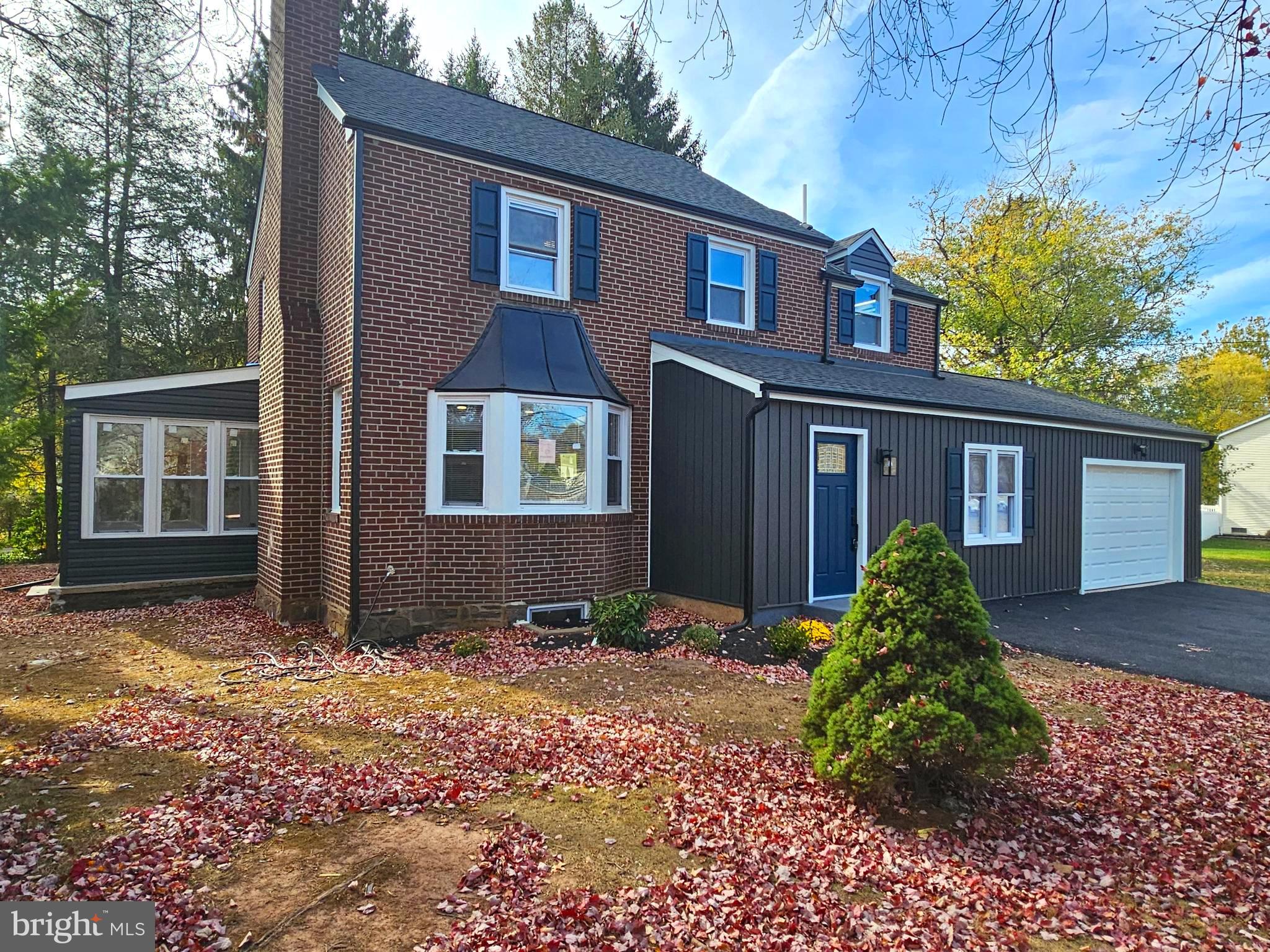 a view of a brick house with a yard