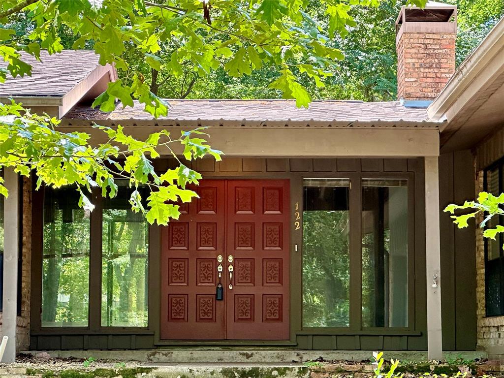 a house with lots of trees in front of it