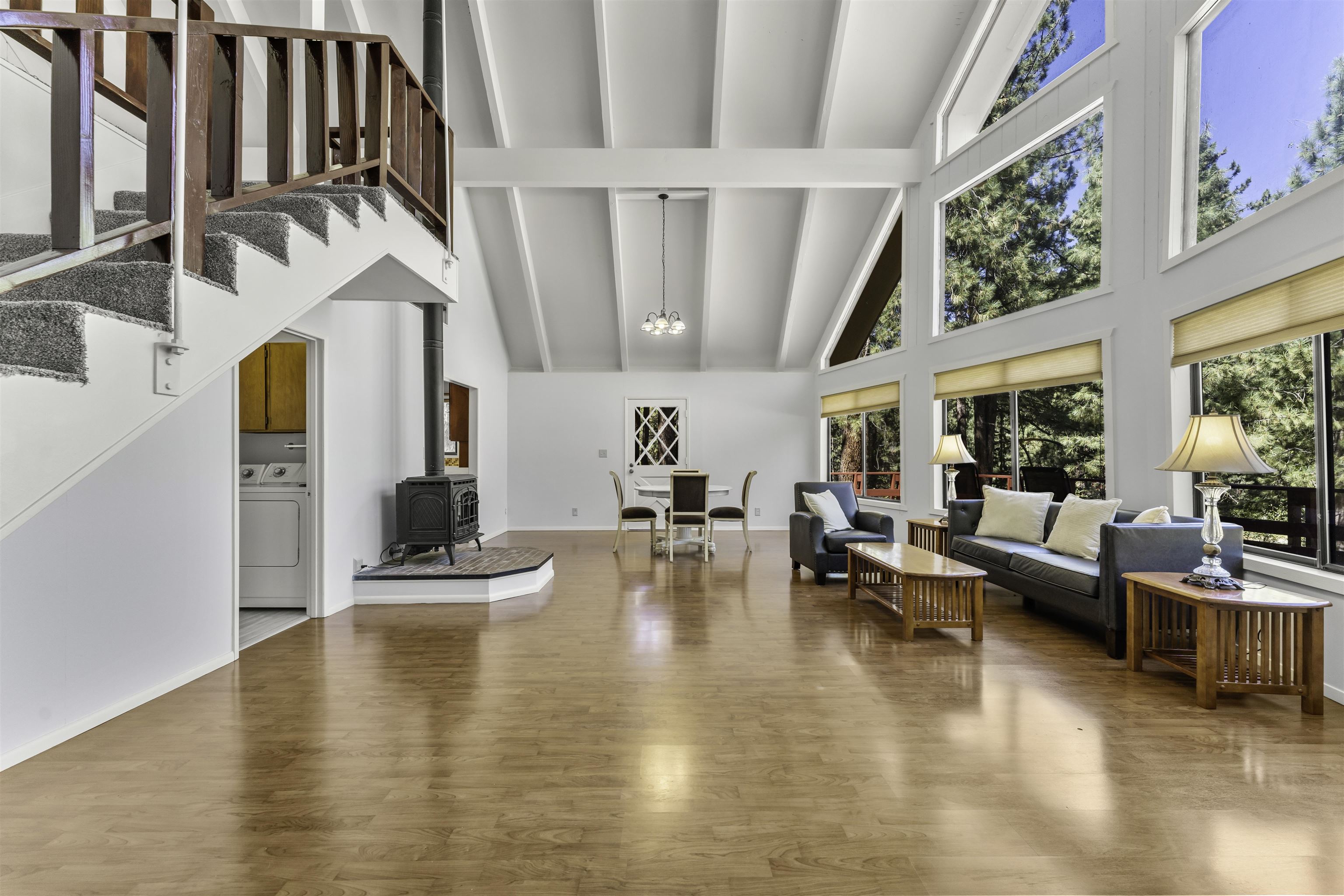 a living room with fireplace furniture and a large window