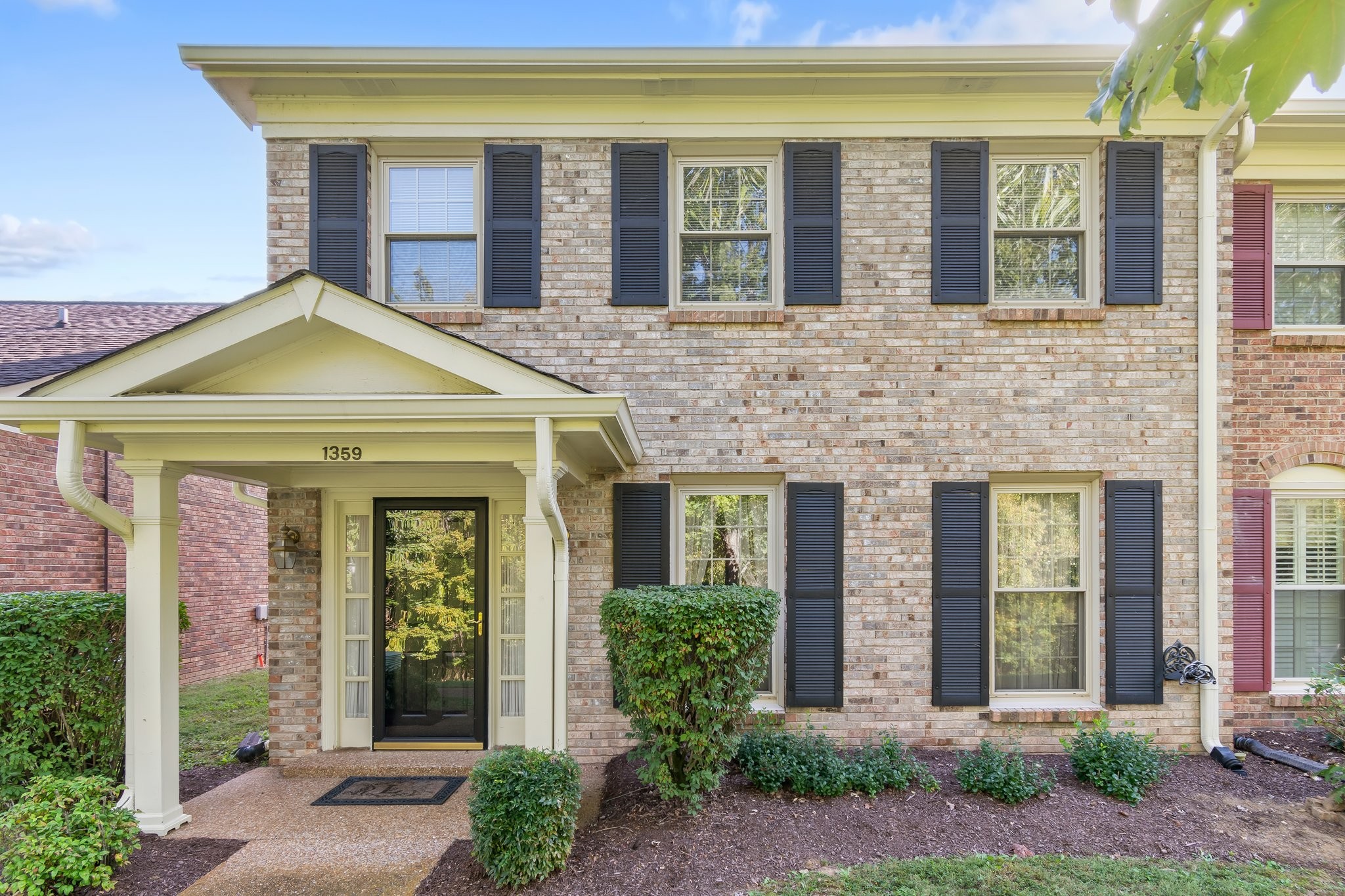 front view of a brick house with a large windows