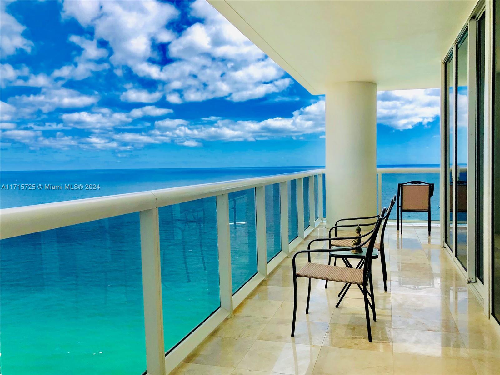 a view of a chairs and table in the balcony