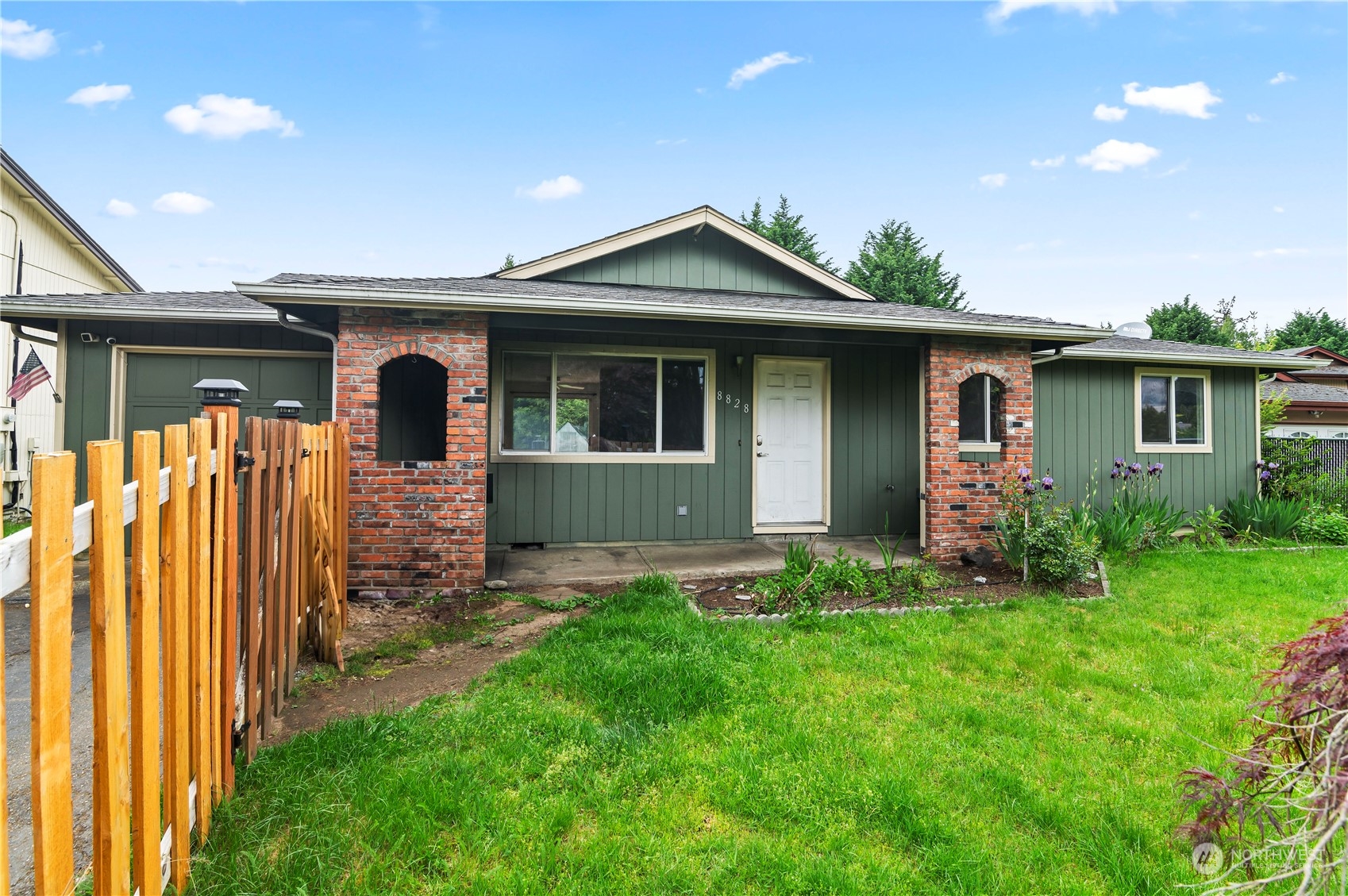 a front view of house with yard and green space