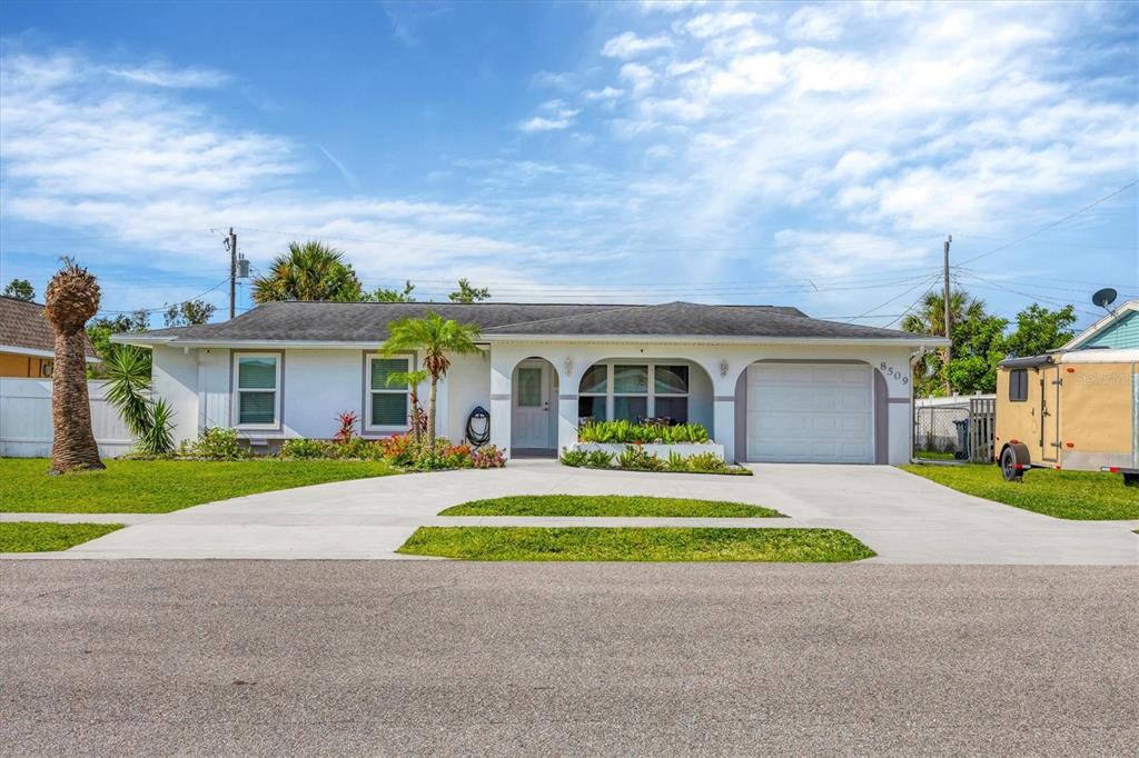 a front view of a house with a yard and garage