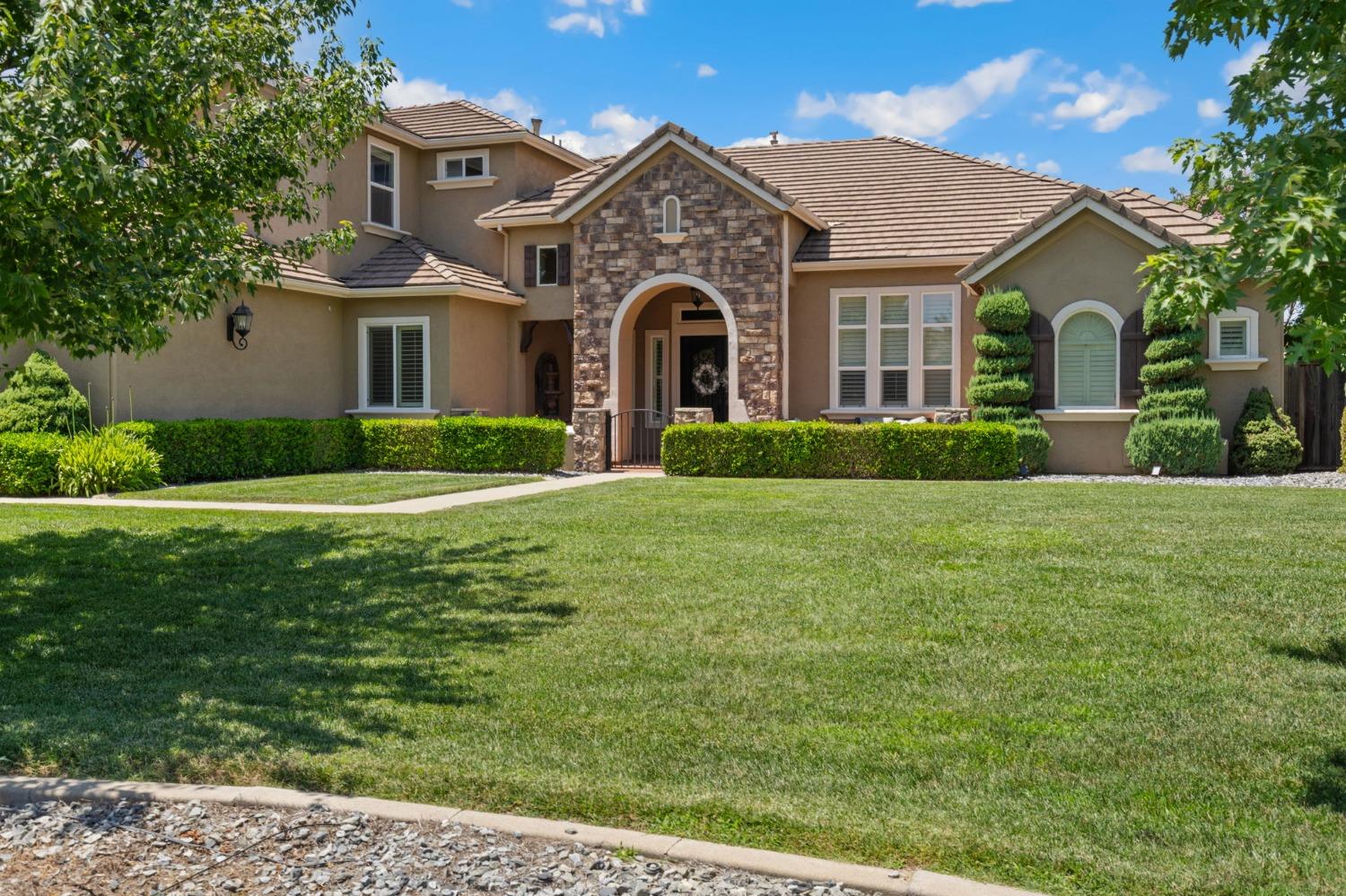 a front view of a house with a yard