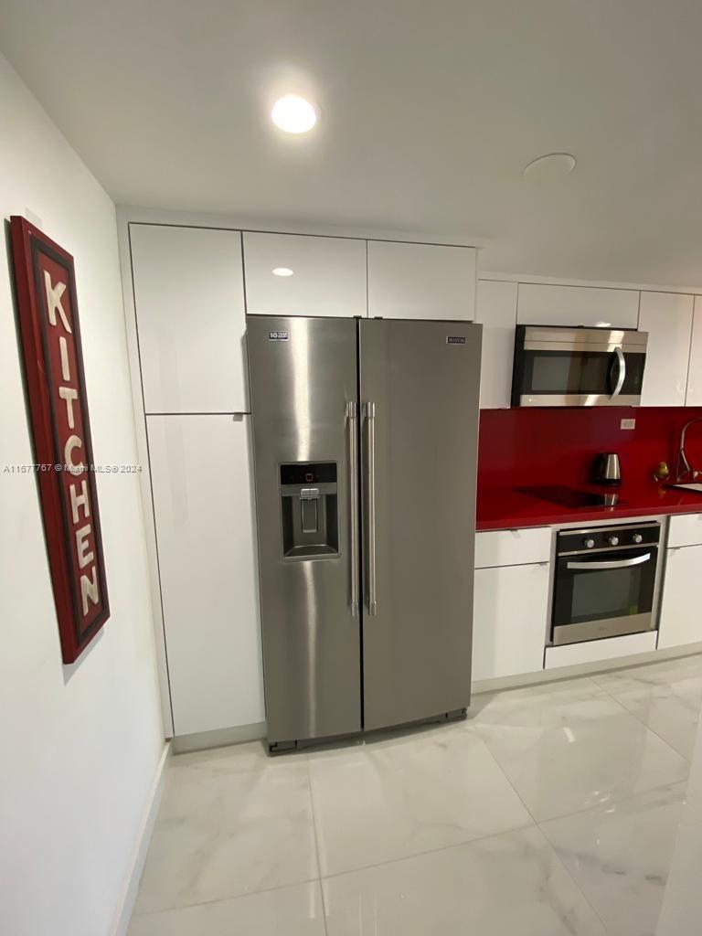 a kitchen with stainless steel appliances a refrigerator and a stove