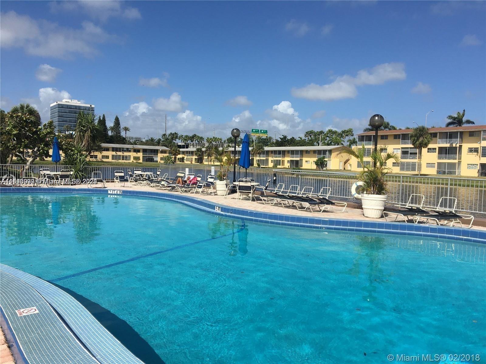 a swimming pool view with a outdoor seating