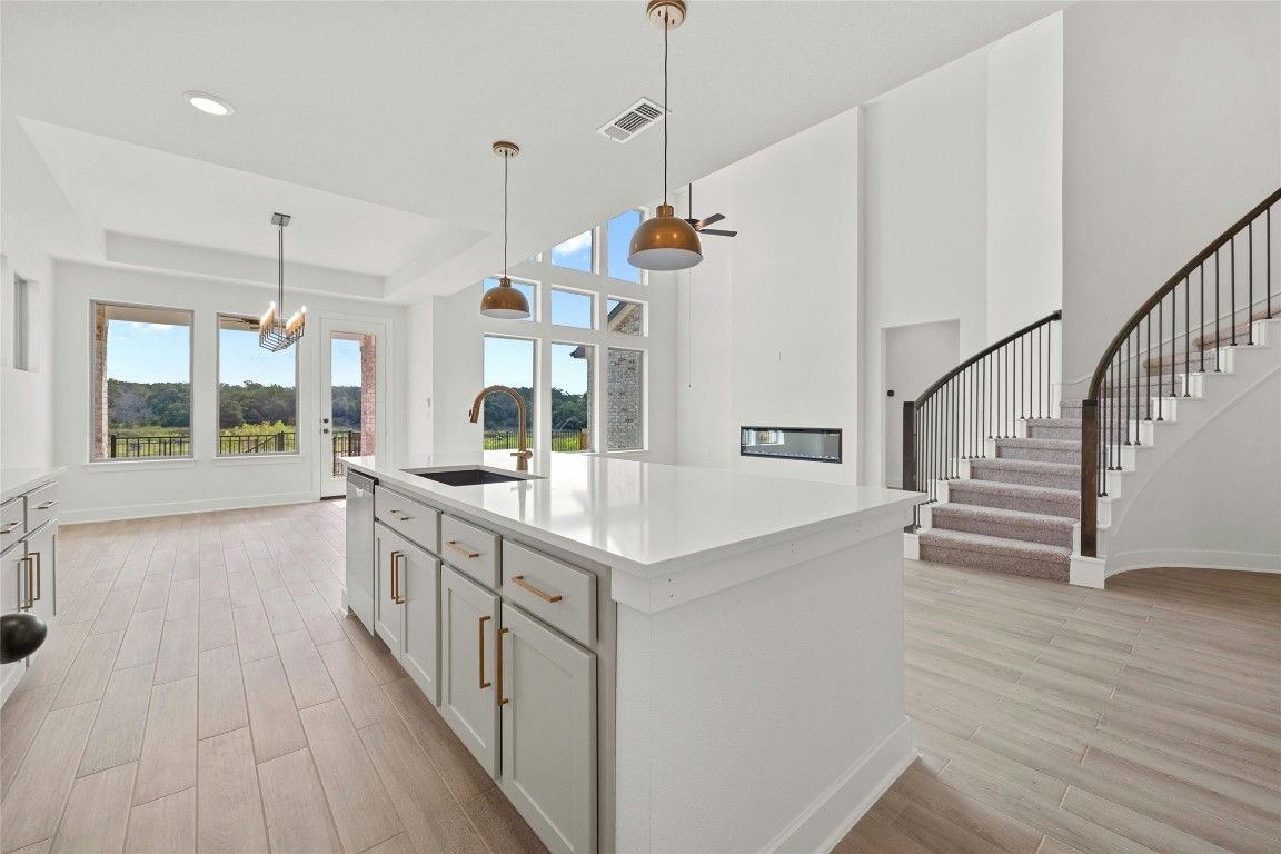 a view of a kitchen with wooden floor and a sink