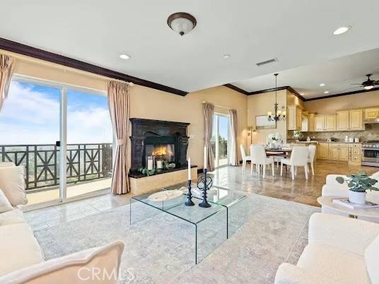 a living room with fireplace furniture and a large window