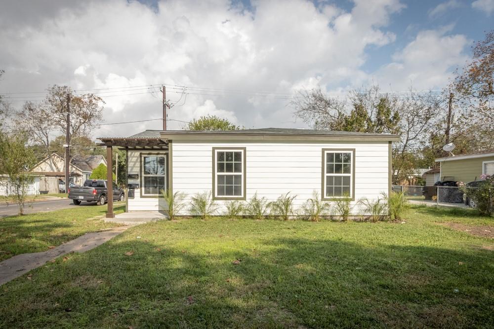 a view of a house with a yard and sitting area