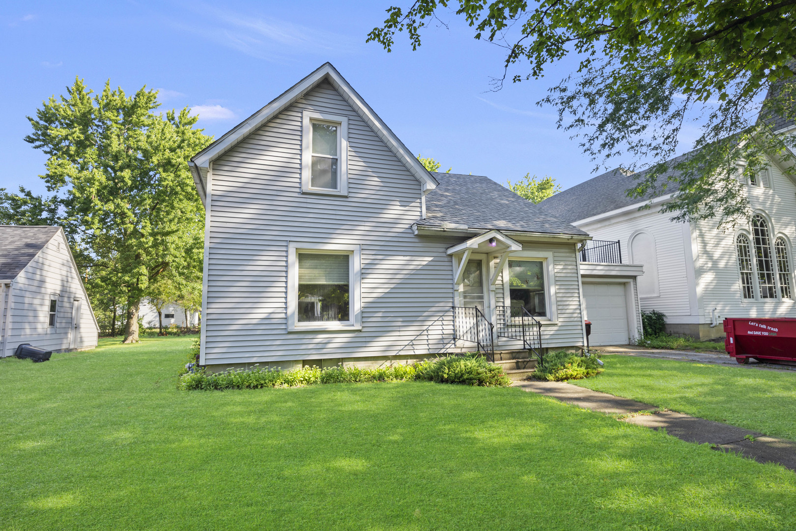 a front view of house with yard and green space