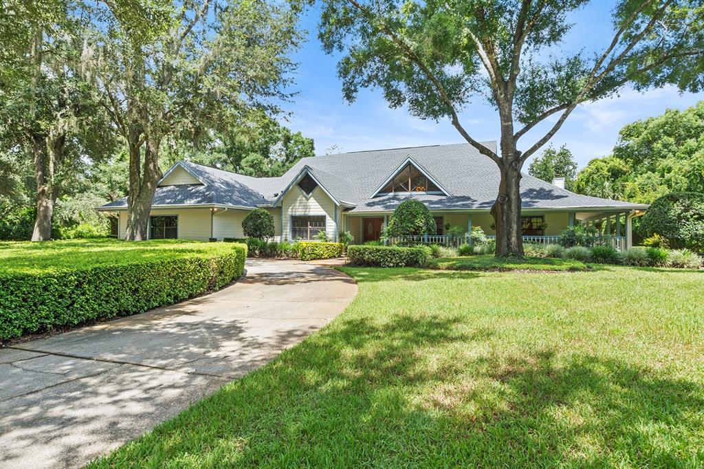 a front view of a house with yard and green space