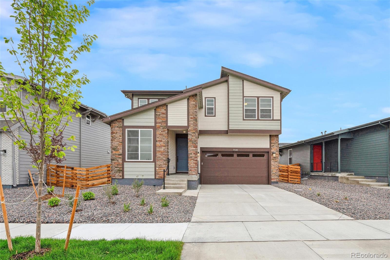 a front view of a house with a yard and garage