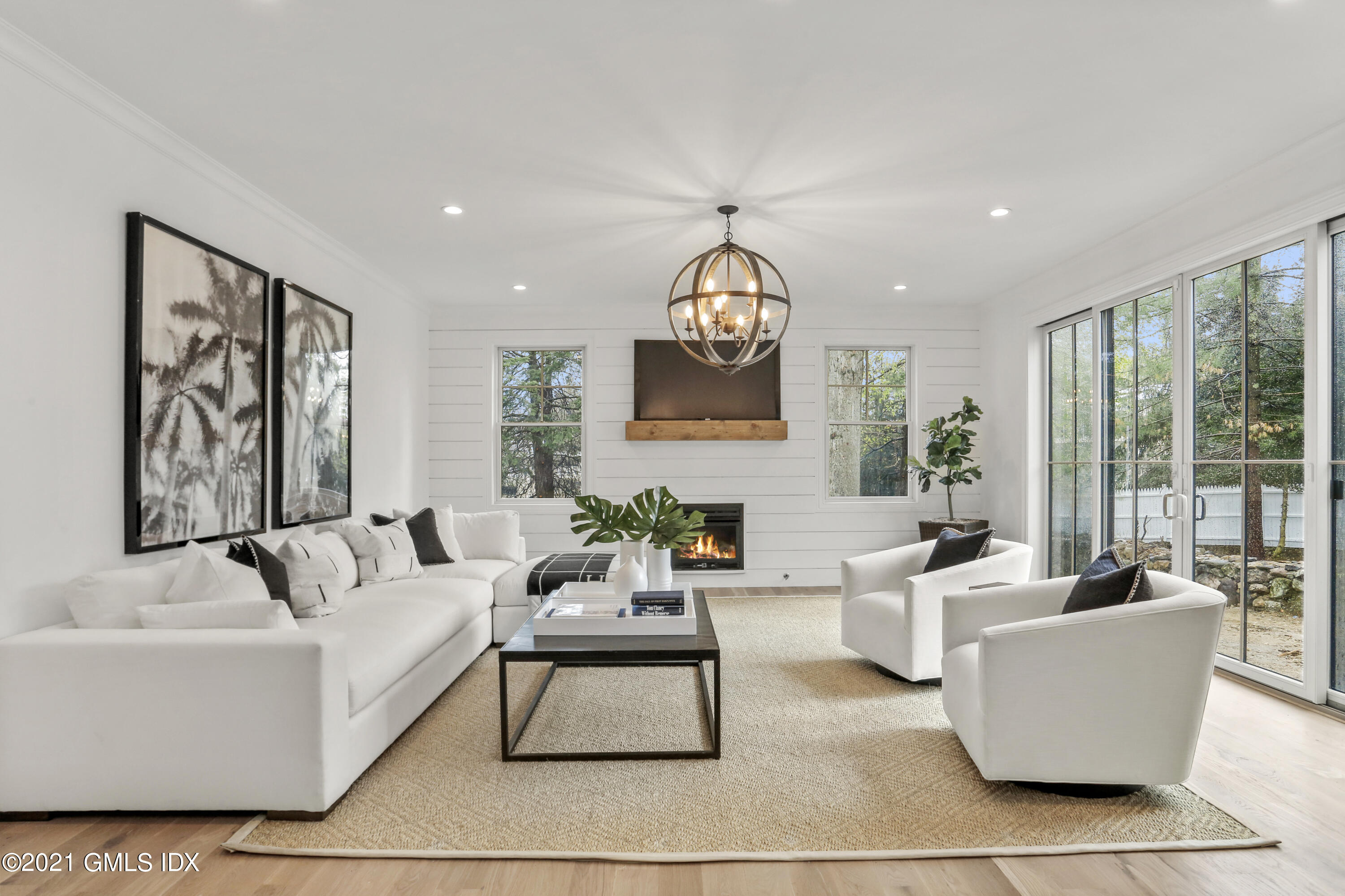 a living room with furniture and large windows