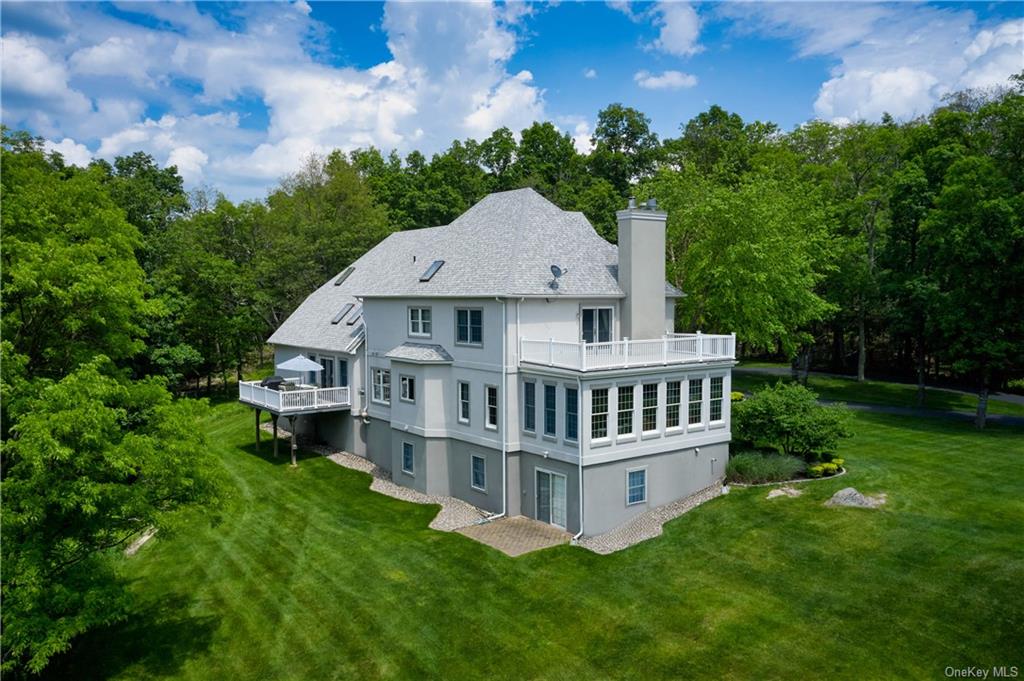 a aerial view of a house with a yard and sitting area