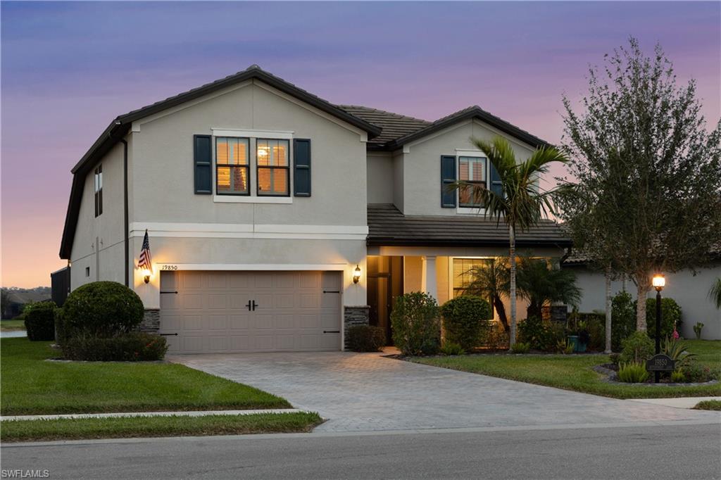 a front view of a house with a yard and garage