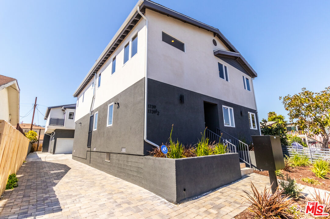 a front view of a house with outdoor seating