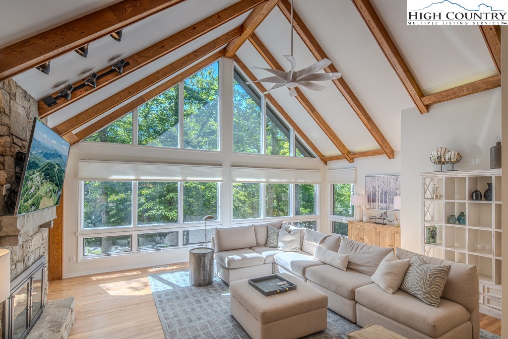 a living room with furniture and a floor to ceiling window