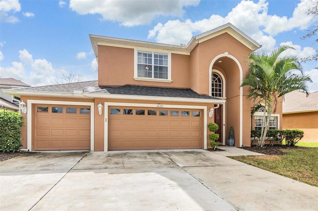 a front view of a house with a yard and garage