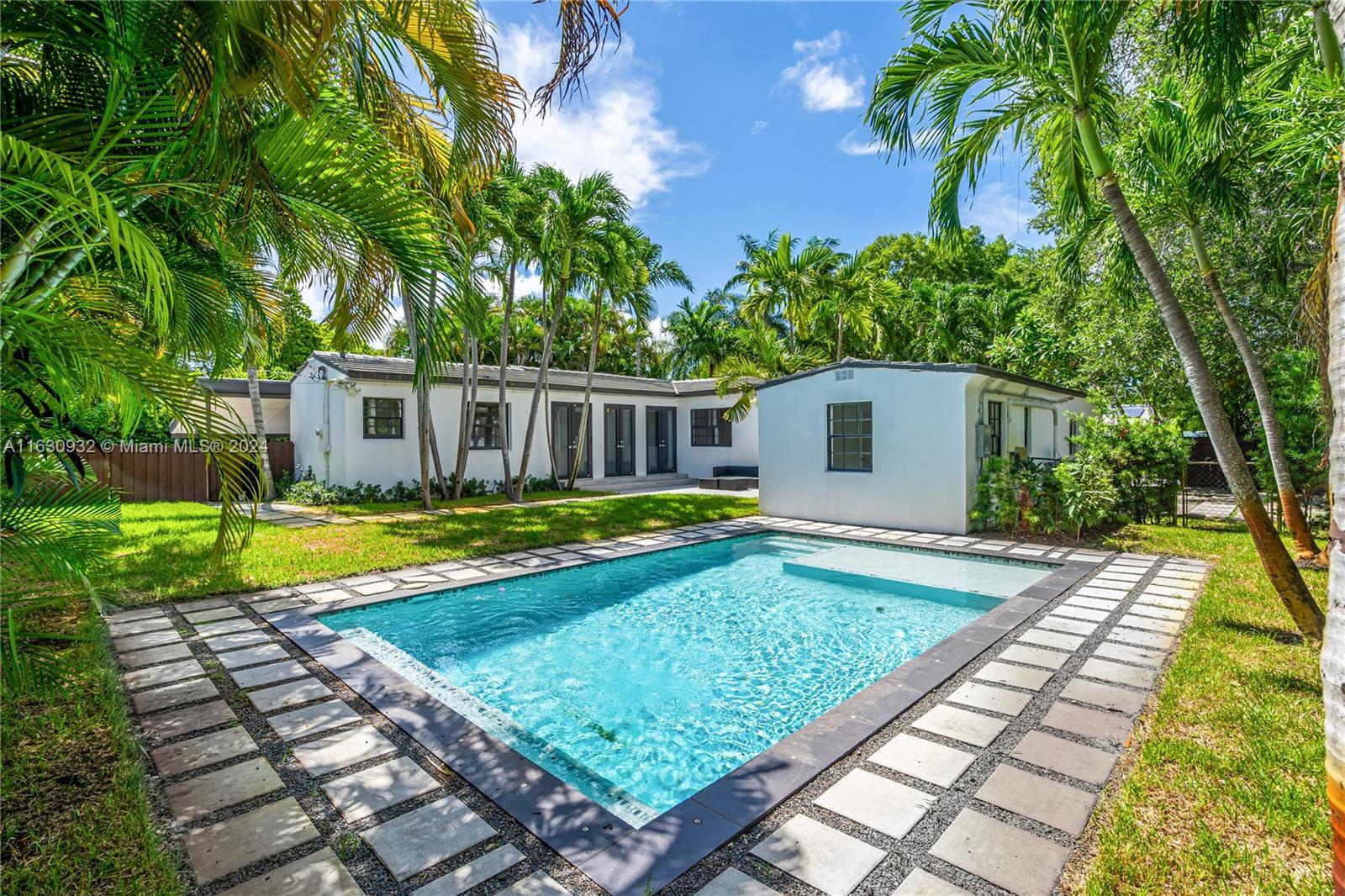 a view of a house with swimming pool and a yard