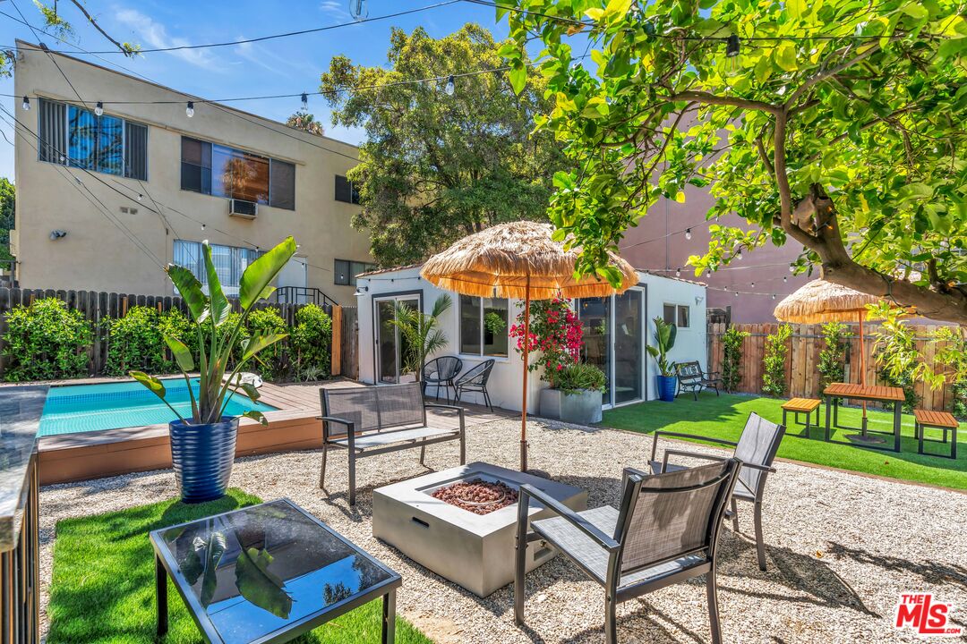 a view of a chairs and table in backyard of the house