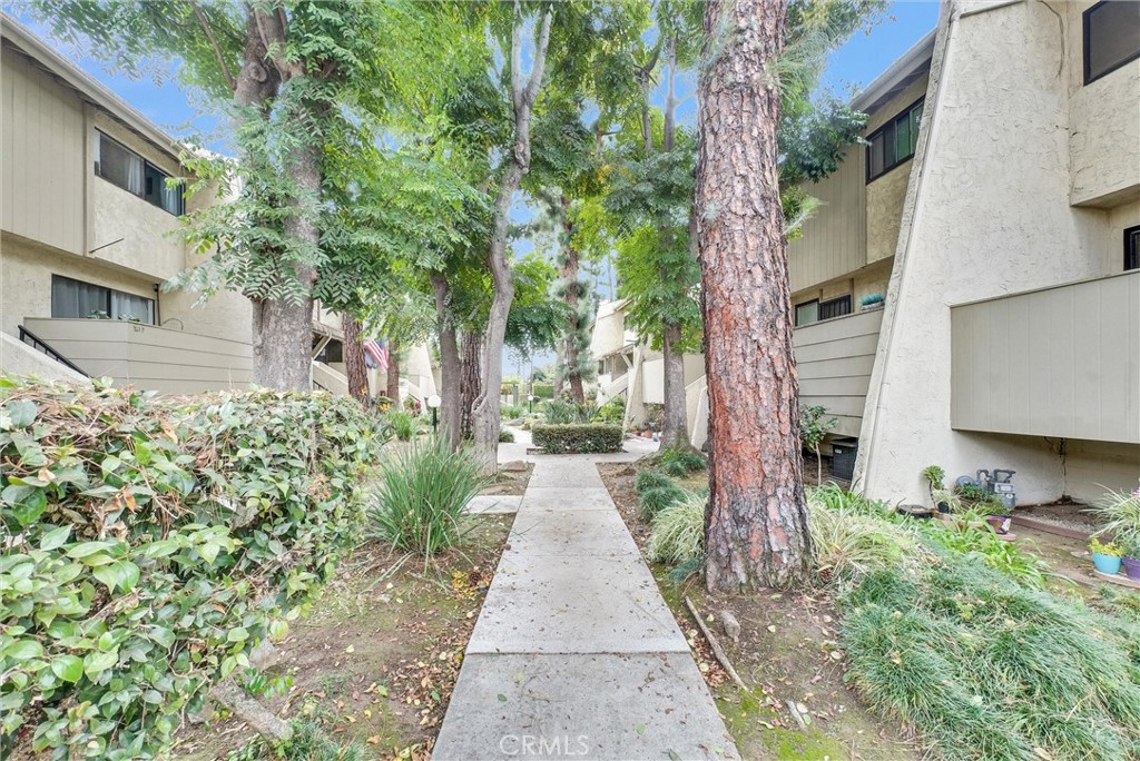 a pathway of a house with a yard