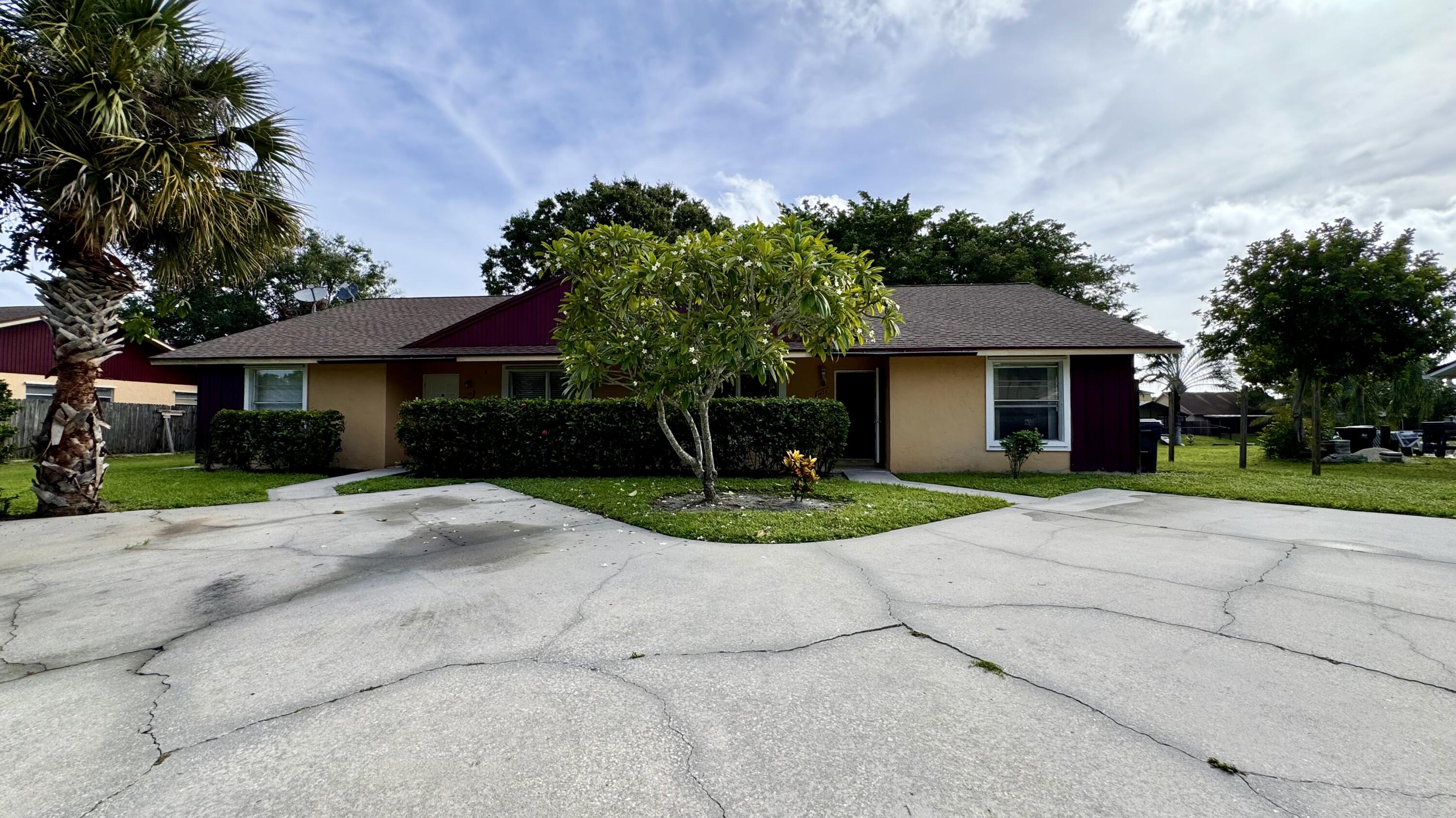 a front view of a house with a yard and a garage