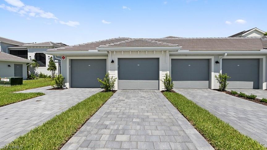 a view of a house with a yard and pathway