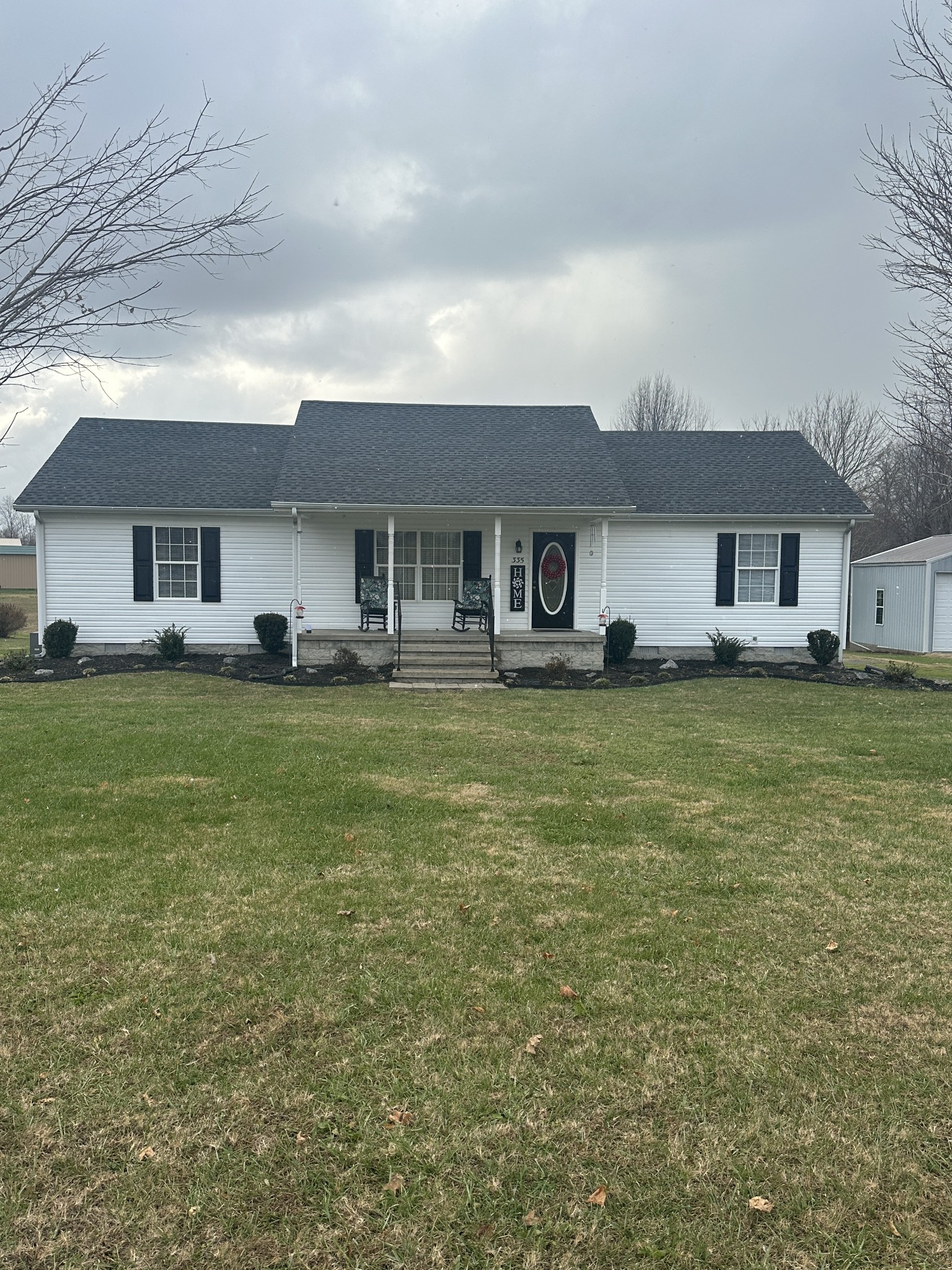 a front view of house with yard and green space