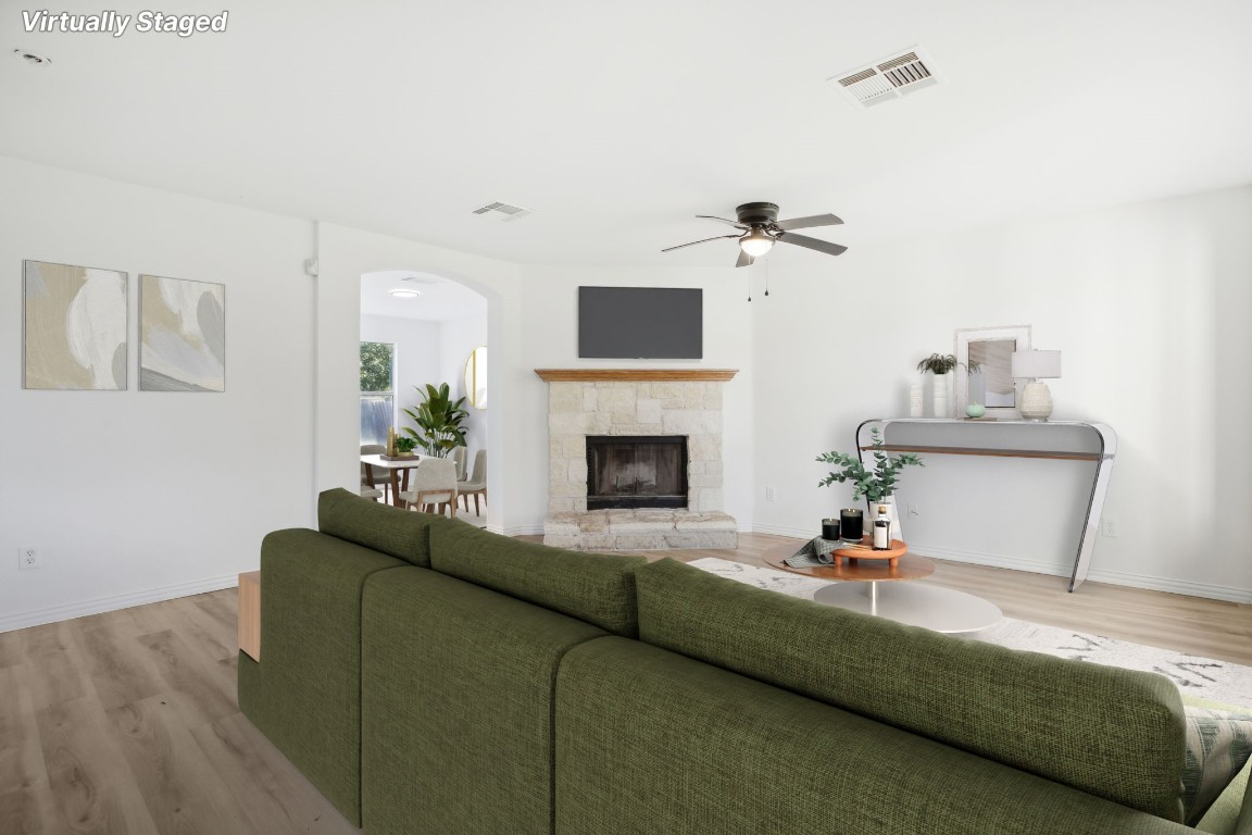 a living room with furniture a fireplace and a flat screen tv