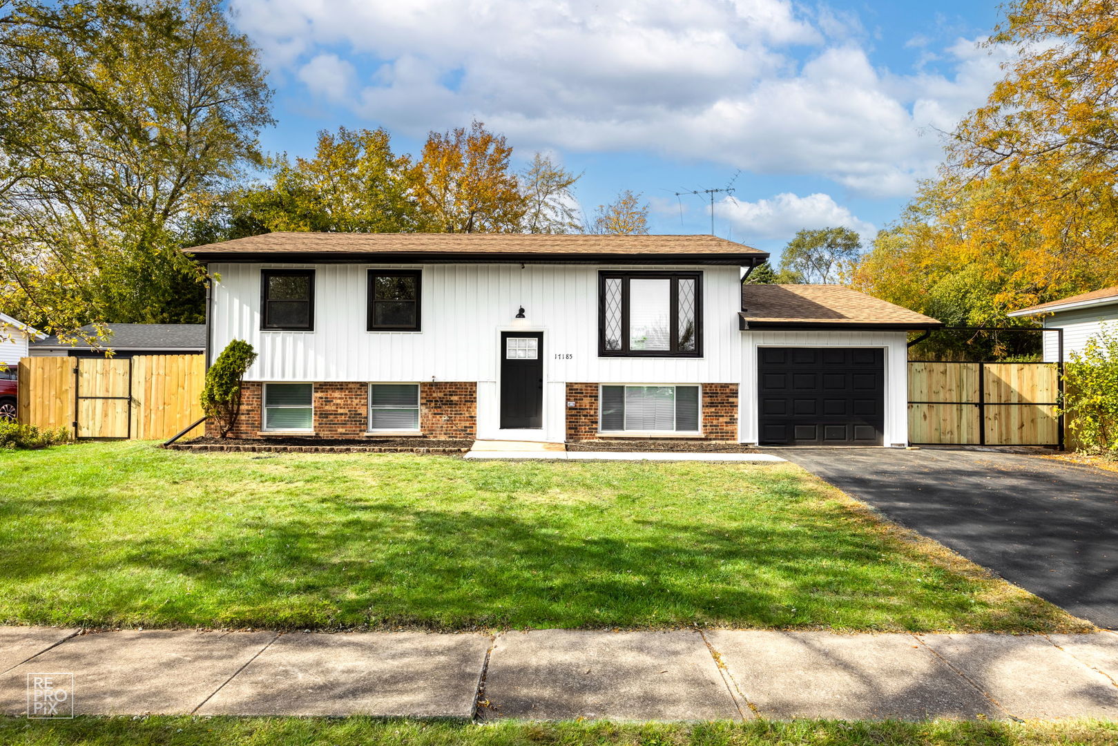 a front view of a house with a garden and yard