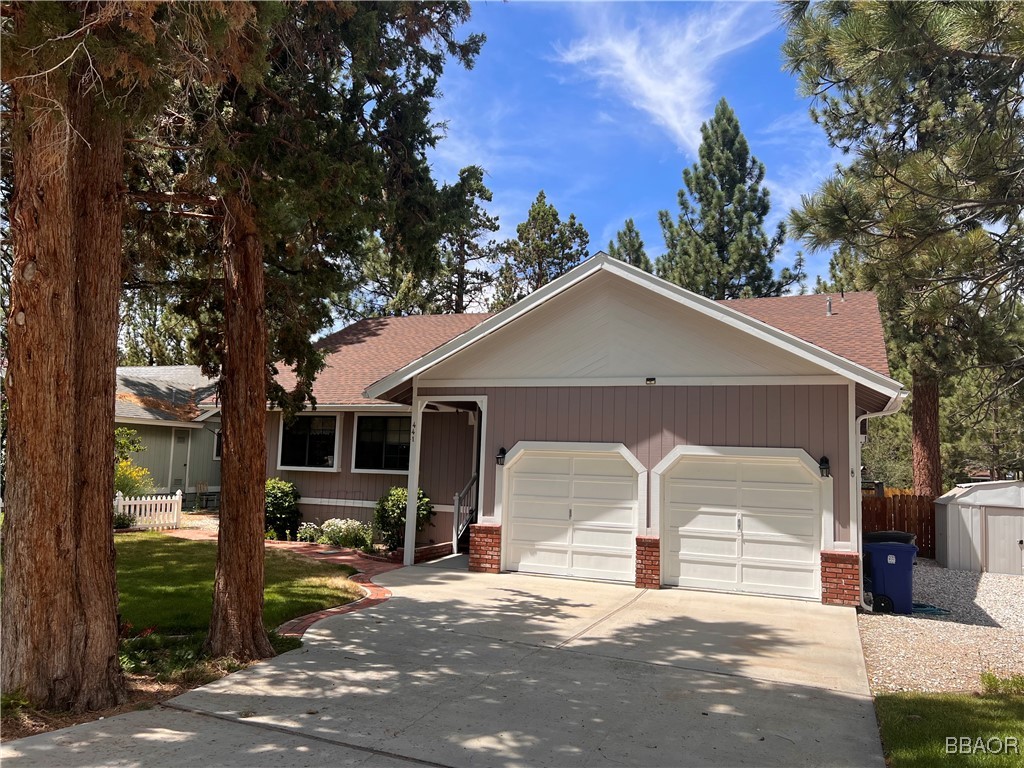 a view of a house with a yard and garage