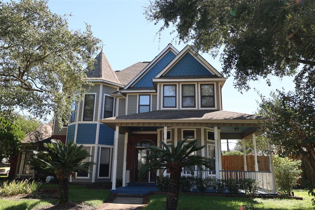 a front view of a house with yard and green space