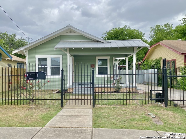 a view of a house with a small yard and plants