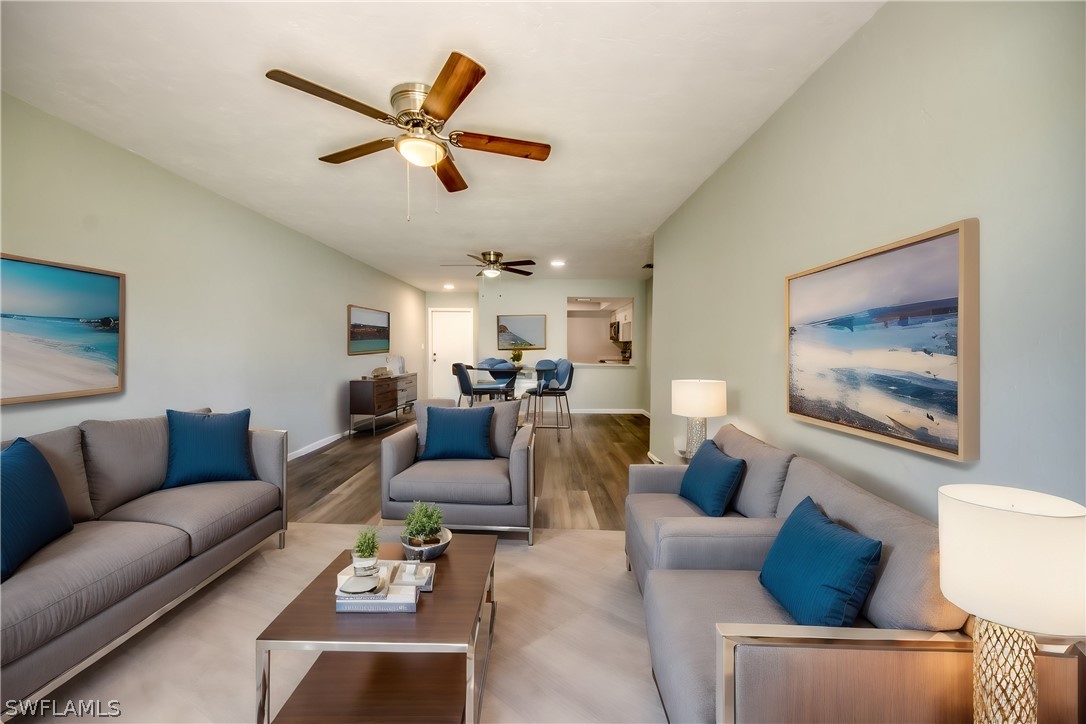 a living room with furniture and a ceiling fan