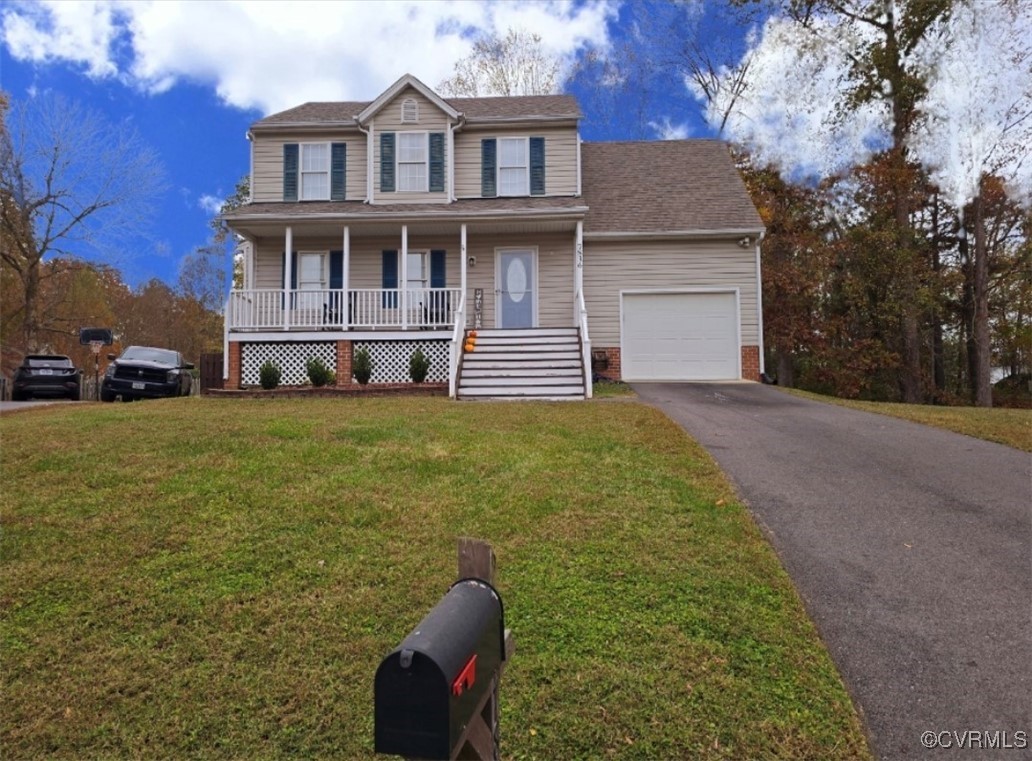 View of front of home featuring a porch, a garage,