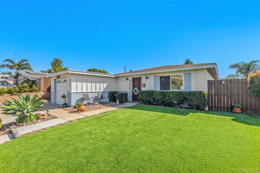 a view of a house with backyard sitting area and swimming pool