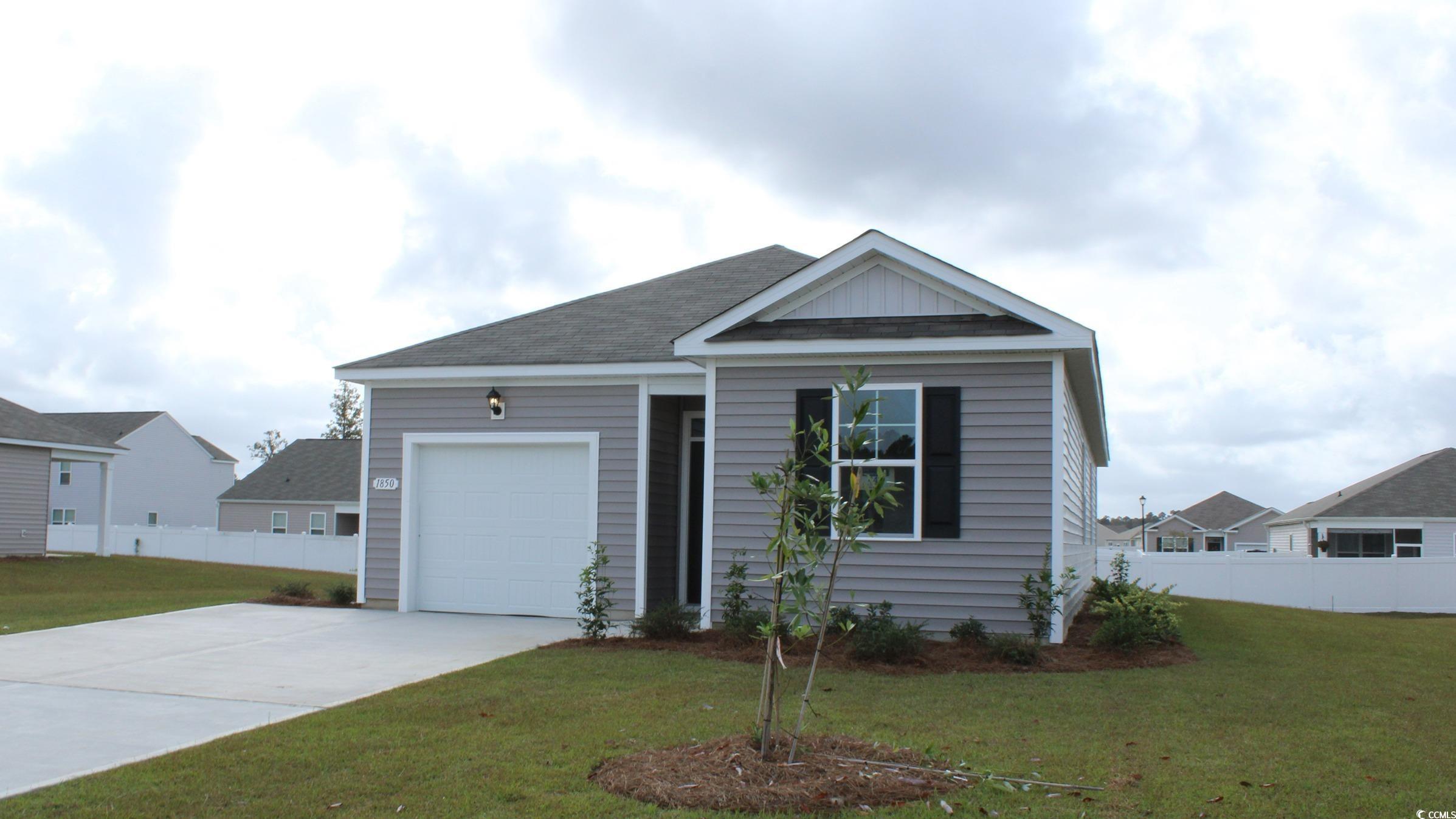 View of front facade featuring a garage and a fron